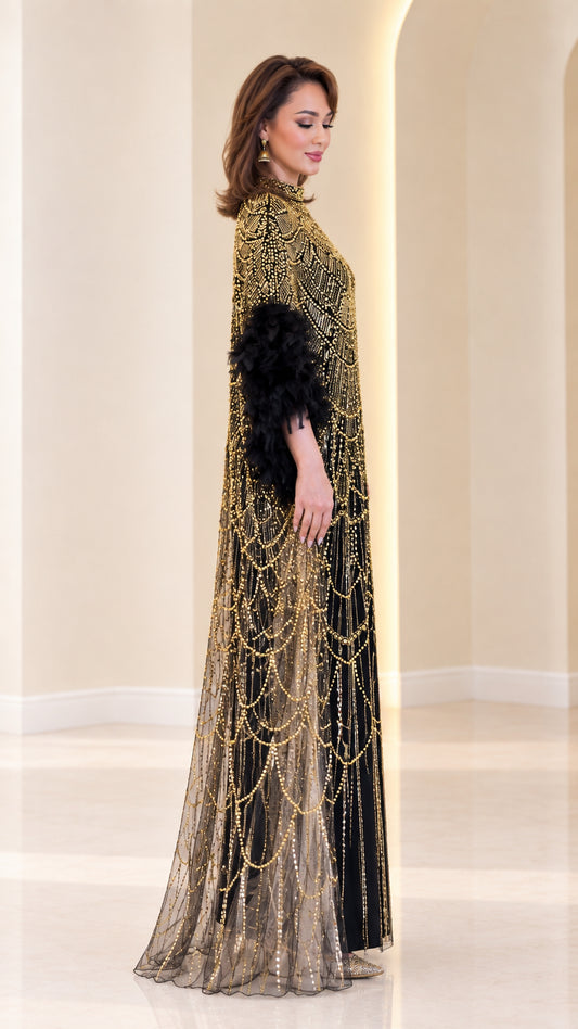 Side profile of woman wearing black and gold beaded cape gown