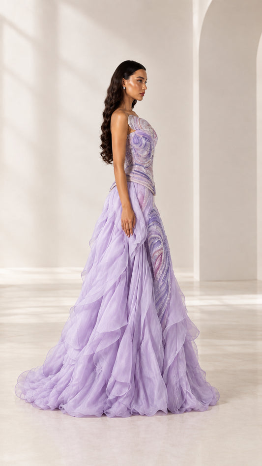 Side angle view of model posing in lavender one-shoulder tiered ruffle evening dress