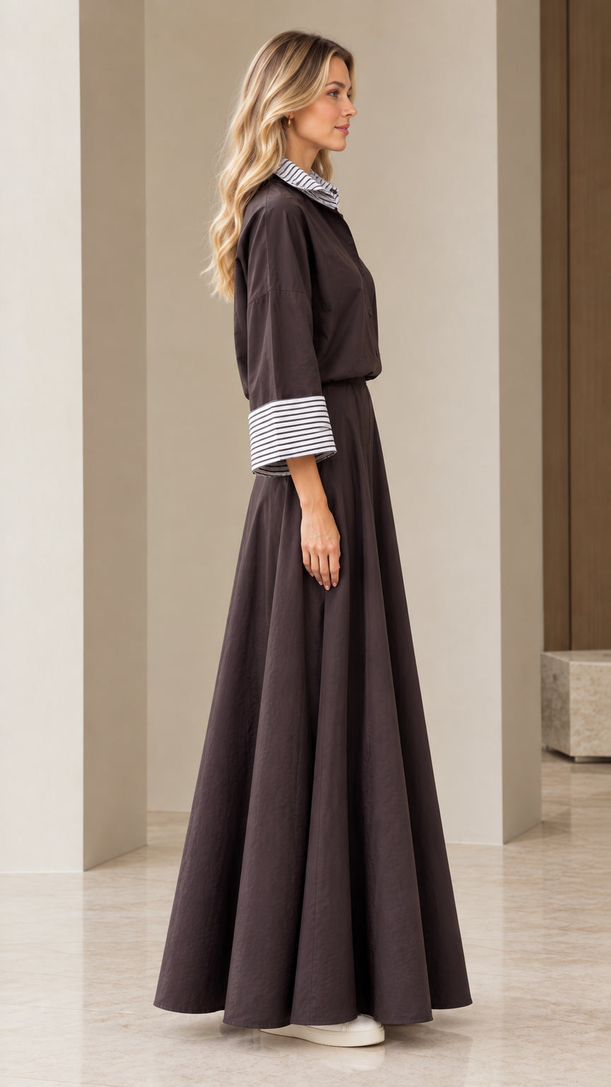 Side view of woman wearing charcoal striped trim shirt and maxi skirt set