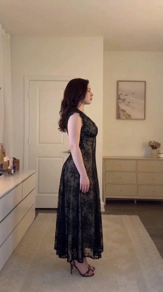 Side profile view of model wearing black floral lace corset midi dress